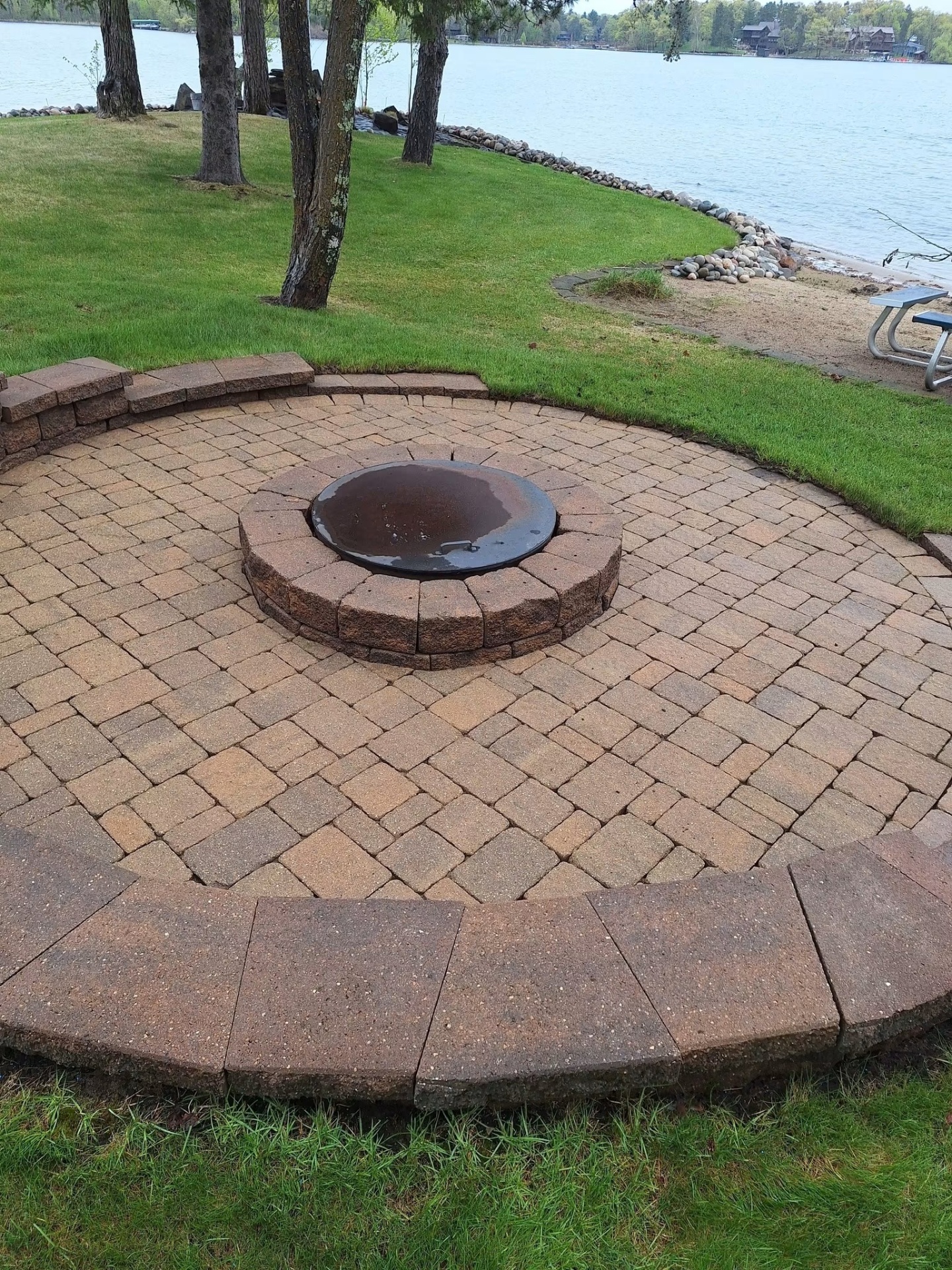Circular paver fire pit patio overlooking the lake