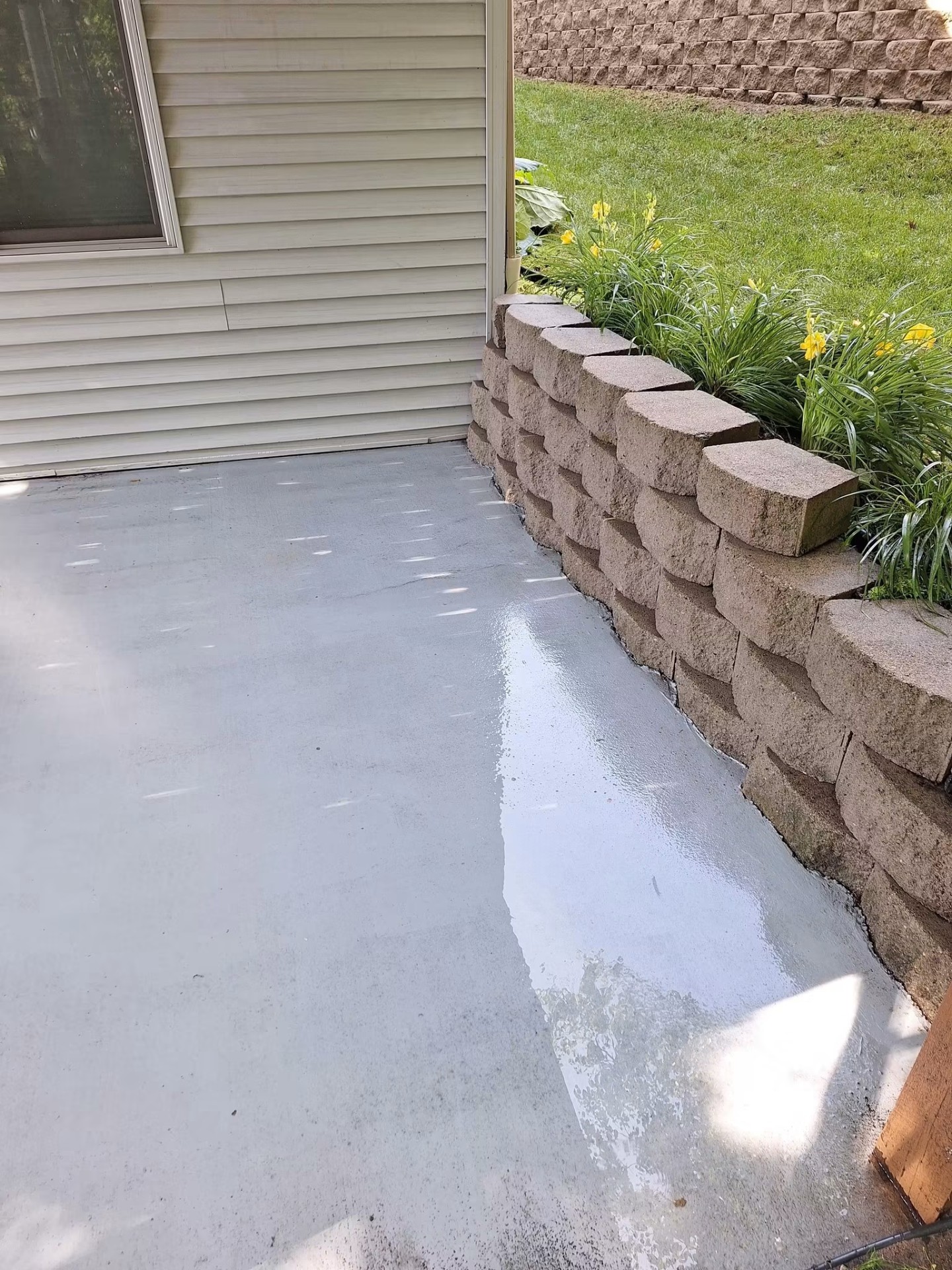 Same concrete patio clean and bright after pressure washing