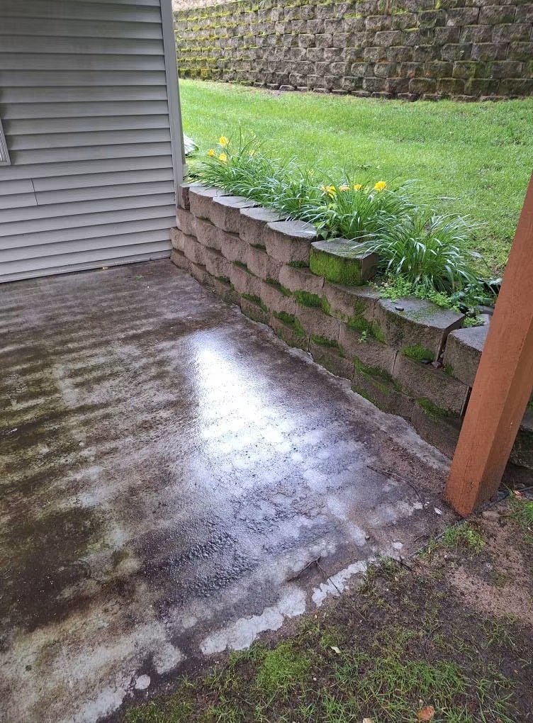 Concrete patio stained and dirty before pressure washing