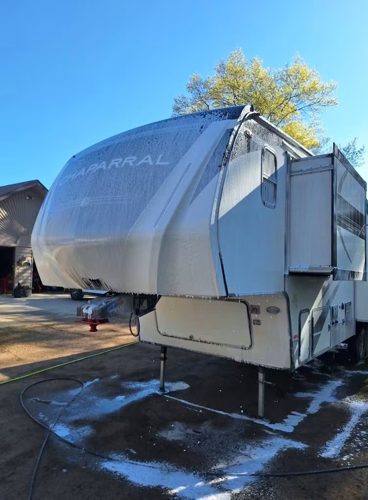 Fifth-wheel camper being soft-washed